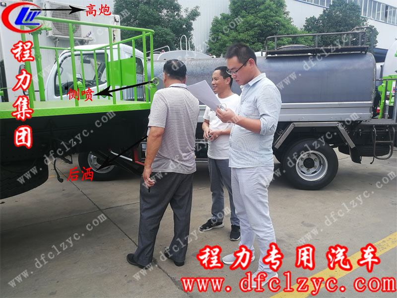 程力銷(xiāo)售人員正在給客戶講解灑水車(chē)的后灑側(cè)噴及高炮功能