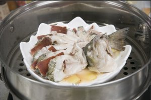 將鱸魚(yú)成花狀擺好，將火腿切片放入各縫隙中，放入鍋中隔水蒸12分鐘拿出，撒上蔥花即可。
